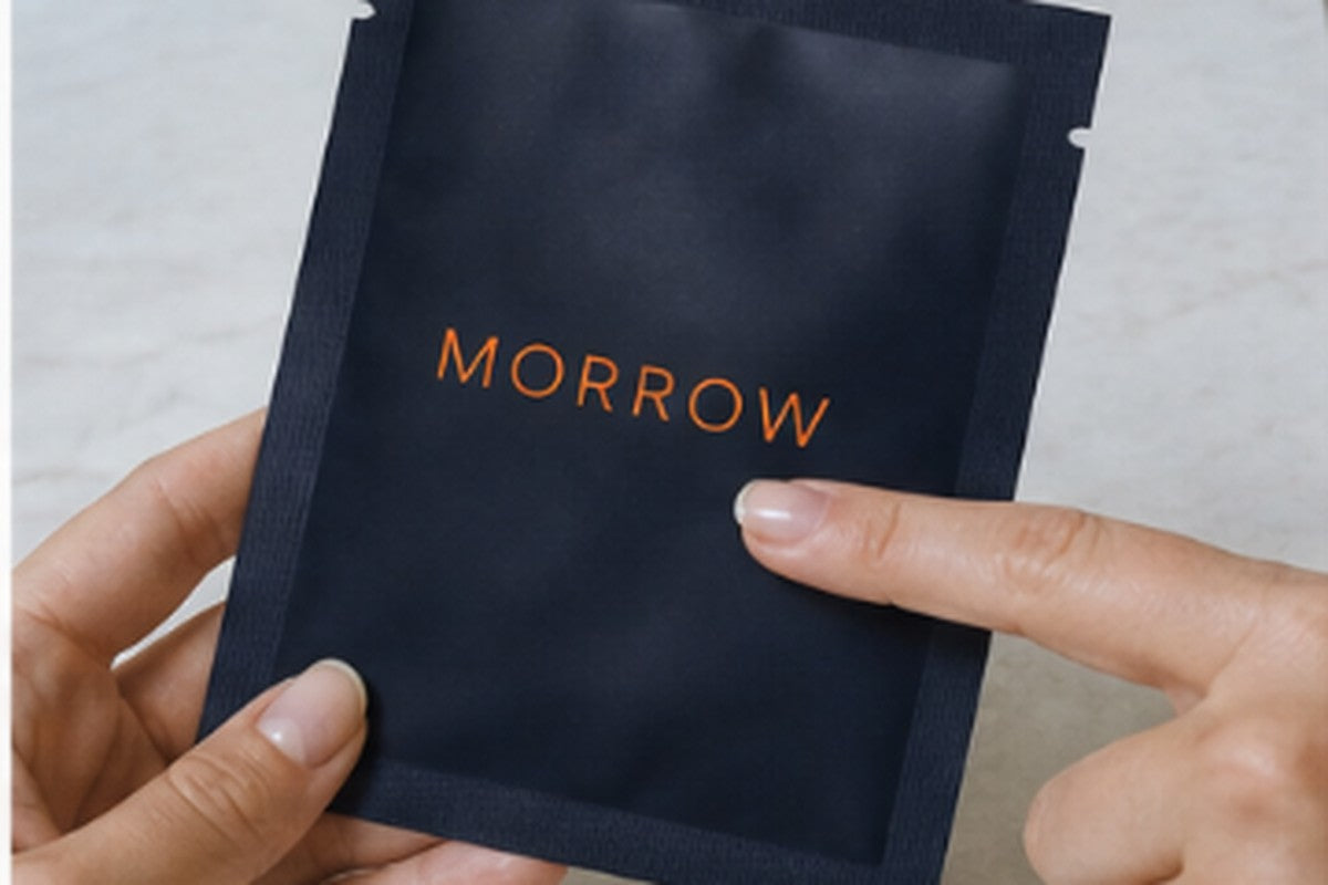 A Morrow sachet and two cooling patches on a plate beside a glass of iced water